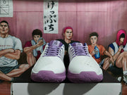 Front view of white and purple Nike basketball shoes with purple laces