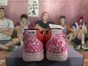 Rear view of the sneakers showing pink patterned heel panels, light-colored midsoles, and “12 AM” labels.