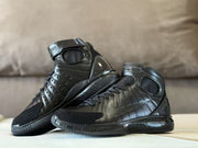 Pair of black high-top shoes shown together from side angles.