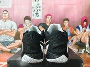 Rear view of black basketball shoes with white outsoles