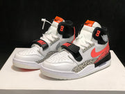 Three-quarter front view of the pair showing perforated toe boxes, white laces, black straps, and coral tongue labels.