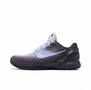 Dark gray and black Kobe 6 sneaker with a pale Swoosh and speckled black outsole.