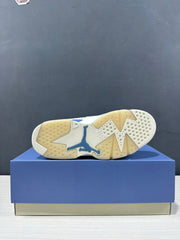 Bottom view showing the cream-and-white outsole pattern with a blue Jordan logo.