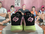 Rear view showing black heel panels with pink embroidered graphics and lime-colored midsoles.
