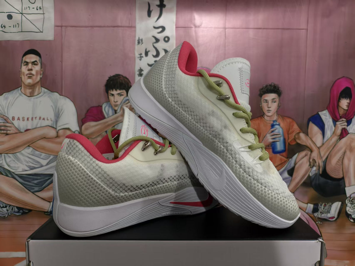 Pair of white and gray Nike basketball sneakers with lemon-green laces and pink accents displayed on a shoebox.