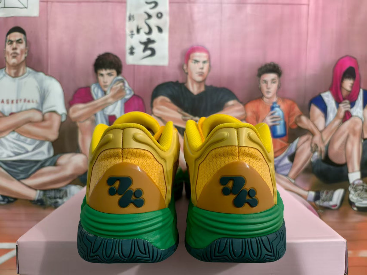 Rear view of yellow sneakers with green midsoles and dark textured outsoles.