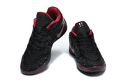 Front view of black Nike basketball shoes with red collars and silver Swoosh logos