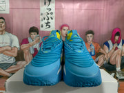 Front view showing blue toe boxes, layered laces, and yellow tongue accents