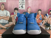 Front view of blue Nike basketball sneakers showing the lace-up design, perforated toe areas and white rubber outsoles.