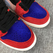 Close-up of the blue perforated toe box, red surrounding panels, black laces, and light outsole.