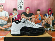 Side profile of a white and black Jordan sneaker with a glossy black overlay