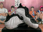 Angled view of the pair highlighting the white sculpted sidewalls, black uppers, laces, and padded collars.