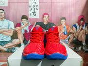 Front view of red and blue Nike basketball sneakers displayed on a shoe box.