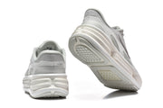 Rear and outsole views of a light grey Nike sneaker.