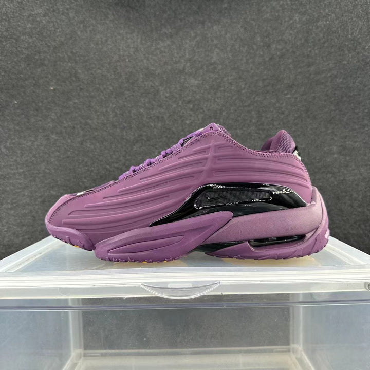Purple low-top sneaker with sculpted side panels and glossy dark side accent