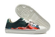 Outsole tread and side view of a multicolor split-toe sneaker.