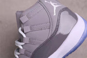 Close-up of the grey sneaker side panel, layered eyelets, stitching, and white Jumpman detail.