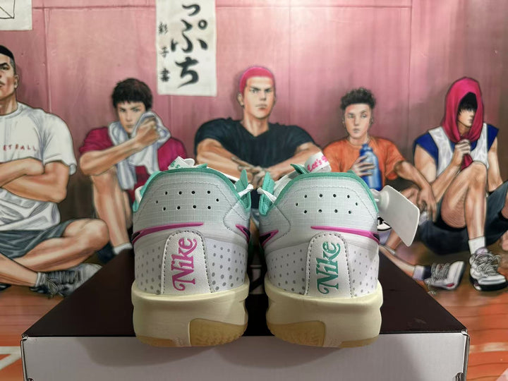 Rear view of white Nike basketball shoes with teal-blue and pink accents