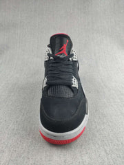 Front view showing black laces, mesh tongue panel, white eyelets, and red outsole details.