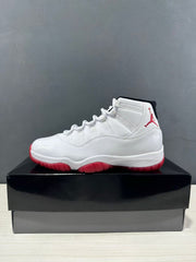 Side profile of a white Jordan Air Jordan 11 Retro Low sneaker with red outsole details.