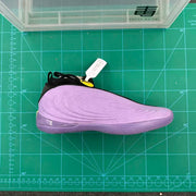 Side profile of a purple Nike basketball shoe with raised ripple detailing and black trim