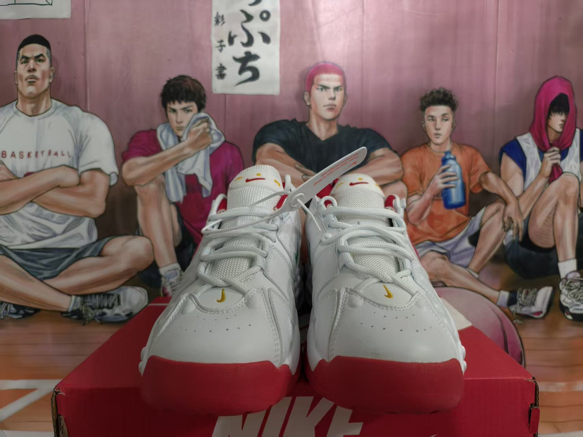 Front view of white Nike sneakers with red toe and outsole accents.