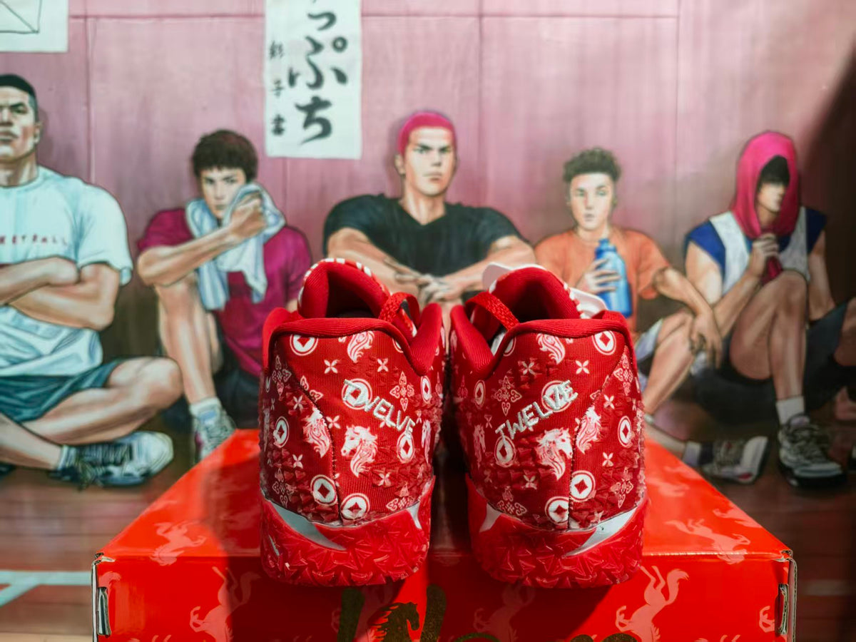 Pair of red patterned Nike sneakers shown from the rear on a red shoebox.
