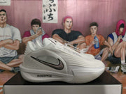 Side view of white Nike basketball sneakers with black Swoosh details and visible ZoomX marking.