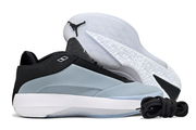 Side view of a blue-gray Jordan 40 sneaker beside its white patterned outsole.