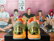 Rear view showing the textured collars, orange padding, and reflective-looking gold heel details.