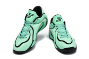 Pair of green and black Jordan sneakers shown from the front, with lace-up closures, black trim, and Jumpman tongue logos.