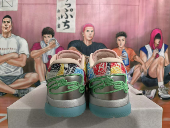 Rear view of multicolor Monopoly-themed Nike basketball shoes with green heel accents and teal outsole sections.