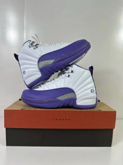 Pair of white and purple Air Jordan 12 Retro sneakers displayed at an angle