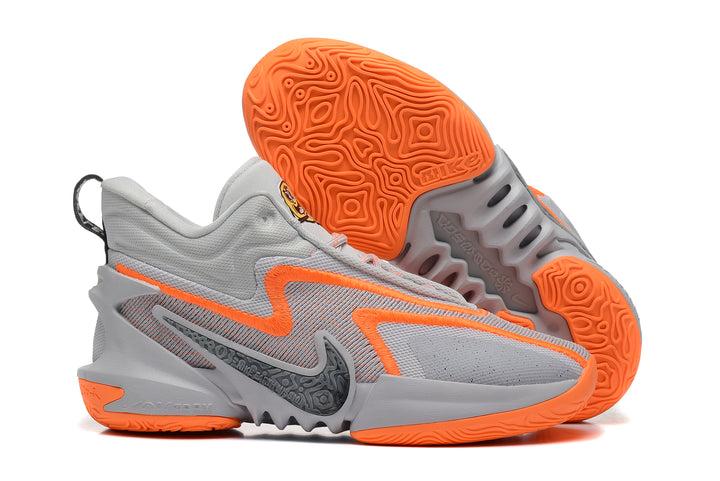 Grey Nike Anthony Edwards 2 basketball shoes with bright orange accents and patterned outsole.