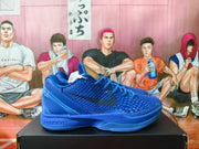 Side view of a blue Nike Kobe basketball sneaker showing the Swoosh and sculpted sole.