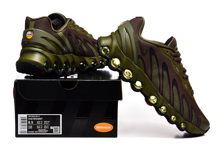 Nike Air Max DN sneakers in olive and brown displayed on a shoe box; the label shows a photographed sample size.