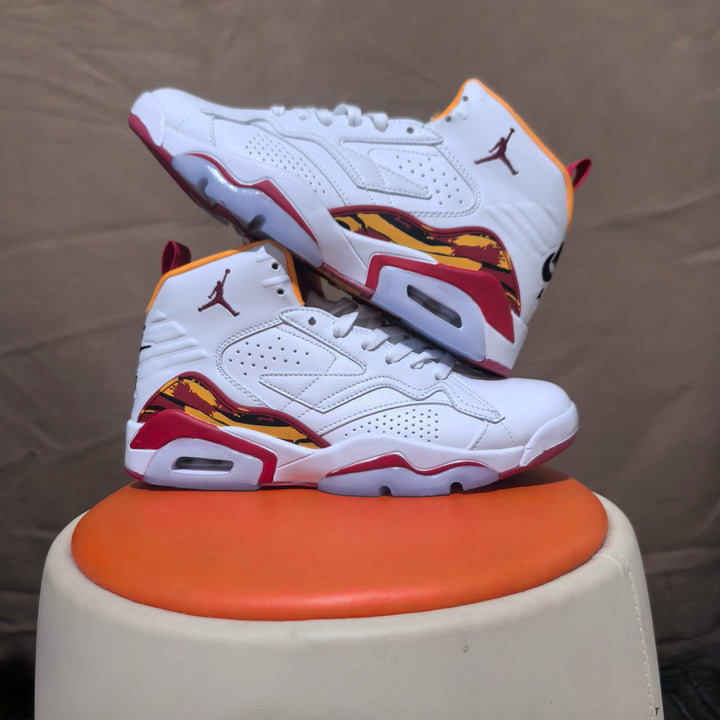 Pair of white Jordan 6-style high-top sneakers with red and yellow accents, shown from the side.