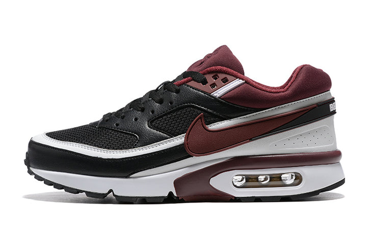 Side view of black, burgundy, and white low-top Nike sneakers with mesh panels, a side Swoosh, and a visible heel air unit.