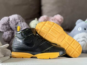 Sneaker side view with the yellow outsole facing upward to show its tread pattern.