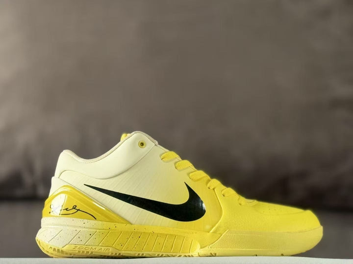 Side view of yellow and cream basketball sneakers with a black Swoosh and yellow outsole.