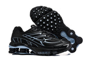 Black Nike Shox R4 sneakers shown from the side and outsole.
