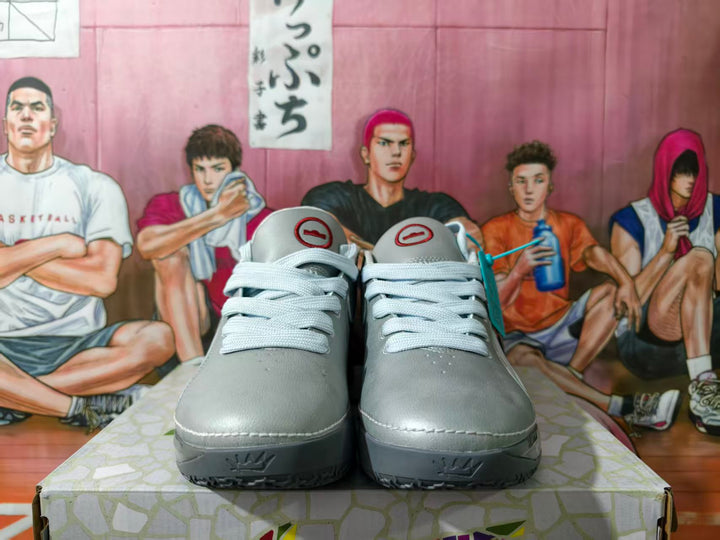 Front view of gray Nike low-top sneakers with white laces and a sculpted gray sole.