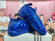 Angled view of royal blue Nike basketball shoes showing their sculpted sides and textured outsoles.