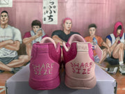 Rear view of pink mismatched Nike sneakers showing contrasting heel colors, “SHARE SIZE” lettering, and “12-AM” heel labels.