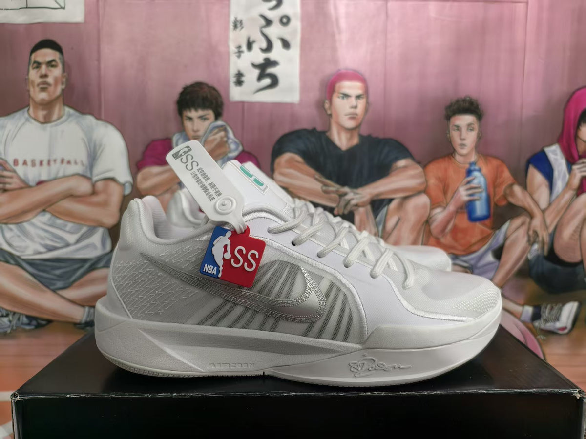 Pair of white Nike basketball sneakers shown in side view with gray Swoosh detailing and basketball-themed hangtags.