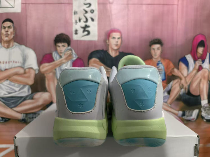 Rear view of gray Jordan basketball sneakers with blue heel panels and light green midsoles.