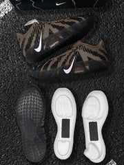 Pair of brown, black and pink Nike sneakers shown with outsole and white cushioning components.