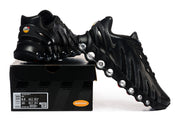 Black Nike Air Max DN sneakers displayed with a shoebox; the box label shows a sample size