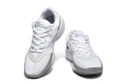 Front and top views of the white and grey Nike GT Cut Academy shoes.