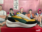 Side view of PUMA Rider Elite sneakers with green side stripe and sculpted white sole
